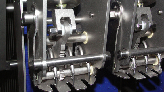 Bearing arrangement of the sliced goods holder in depositing fork design. Drive occurs via pneumatic cylinders for realisation of the swivelling motion with iglidur® J plain bearings.